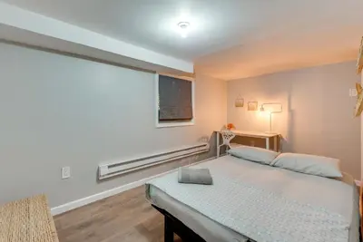 a bedroom with a bed and a large window at Game Room and Deck Family Home in Tobyhanna! in Tobyhanna