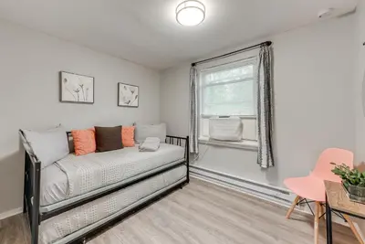 a bedroom with a bed and a window at Game Room and Deck Family Home in Tobyhanna! in Tobyhanna