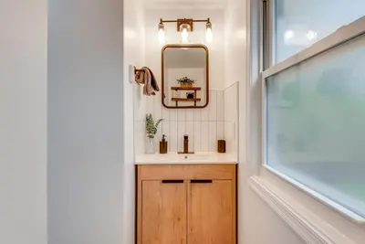 a bathroom with a sink and a mirror at Game Room and Deck Family Home in Tobyhanna! in Tobyhanna