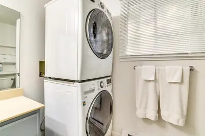 a white laundry room with a washer and dryer at Walk to Lake Carobeth Gem in Pocono Country Place in Tobyhanna