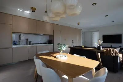 a kitchen and dining room with a wooden table and chairs at RARE Luxurious Apartment 1 Block From Time Square in New York