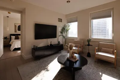 a living room with a television and a bed at RARE Luxurious Apartment 1 Block From Time Square in New York