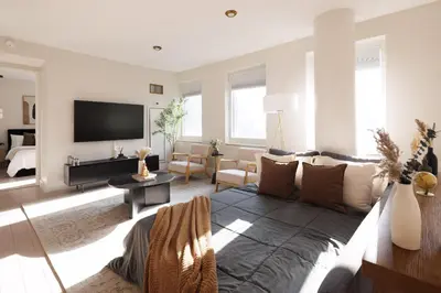 a living room with a couch and a tv at RARE Luxurious Apartment 1 Block From Time Square in New York