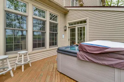 a hot tub on the deck of a house at Less Than 1 Mi to Big Boulder Mtn! Home with Hot Tub and Deck in Lake Harmony