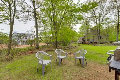a group of three chairs sitting in the grass at Less Than 1 Mi to Big Boulder Mtn! Home with Hot Tub and Deck in Lake Harmony