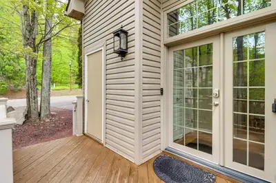 a front door of a house with a wooden deck at Less Than 1 Mi to Big Boulder Mtn! Home with Hot Tub and Deck in Lake Harmony
