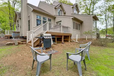 a house with two chairs and a grill in front of it at Less Than 1 Mi to Big Boulder Mtn! Home with Hot Tub and Deck in Lake Harmony