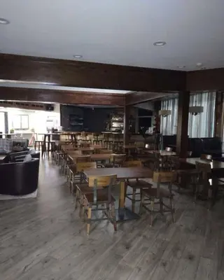 a dining room with wooden tables and chairs at Joy Cabin Where Family Friends Make Memories in Long Pond