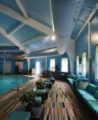 a swimming pool with couches and a swimming pool at Joy Cabin Where Family Friends Make Memories in Long Pond