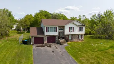 a house with a yard with a garage at Joy Cabin Where Family Friends Make Memories in Long Pond