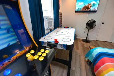 a childs room with a table and a video game at Bool Bear Lodge a pet friendly Pocono Vacation Home with Fireplace, BBQ and more in Tobyhanna