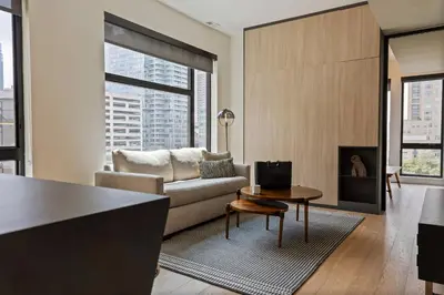a living room with a couch and a fireplace at Sosuite at The Onyx - Museum District in Philadelphia