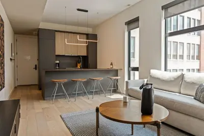 a living room with a couch and a table at Sosuite at The Onyx - Museum District in Philadelphia