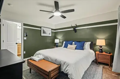 a bedroom with a bed and a ceiling fan at 5 Br Sleeps 14 Hot Tub-Sauna-Movie Theatre-Arcade in Albrightsville