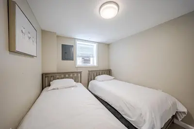 two beds in a small room with a window at Harmony House in Liberty