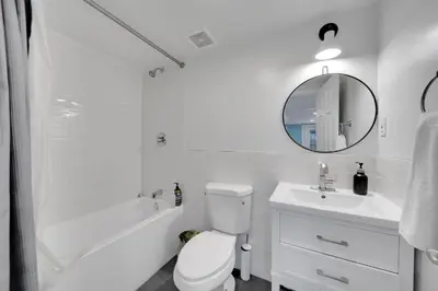 a white bathroom with a toilet and a sink at Harmony House in Liberty