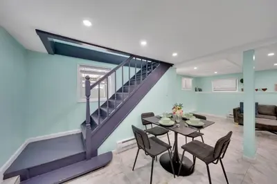 a living room with a staircase and a table and chairs at Harmony House in Liberty
