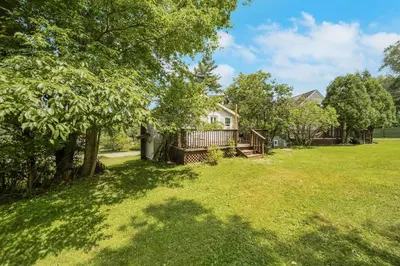 an open yard with a house and trees at Harmony House in Liberty