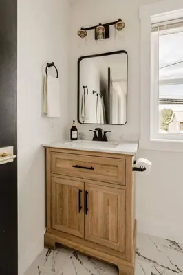 a bathroom with a sink and a mirror at Modern Amish Country Retreat w/ Hot Tub. in Leola