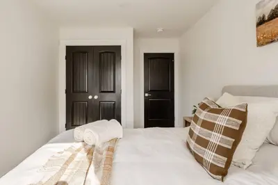 a white bed with two towels on top of it at Modern Amish Country Retreat w/ Hot Tub. in Leola
