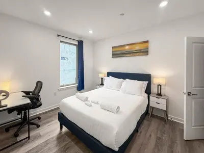 a bedroom with a bed and a desk and a computer at Apartmint at Fishtown Flats - Philadelphia in Philadelphia