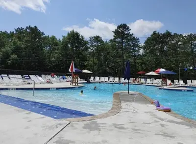 a large swimming pool with chairs and people in it at Masthope Retreat in Lackawaxen