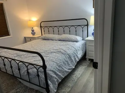 a bedroom with a bed and two night stands at Masthope Retreat in Lackawaxen