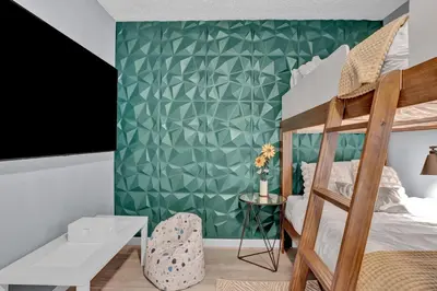 a bedroom with a bunk bed and a green wall at Pocono Blue with Paddleboards, Spa, Indoor Jacuzzi, GameRoom, Lake, EV in Gouldsboro