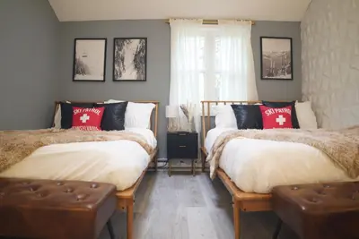 a bedroom with two beds with red and white pillows at Pocono Blue with Paddleboards, Spa, Indoor Jacuzzi, GameRoom, Lake, EV in Gouldsboro