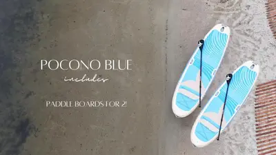 a pair of surfboards sitting on the sand at Pocono Blue with Paddleboards, Spa, Indoor Jacuzzi, GameRoom, Lake, EV in Gouldsboro