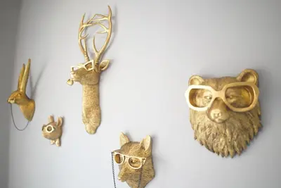 a wall with a bunch of animal masks and glasses at Pocono Blue with Paddleboards, Spa, Indoor Jacuzzi, GameRoom, Lake, EV in Gouldsboro