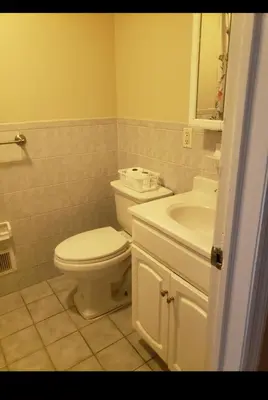a bathroom with a toilet and a sink at Beautiful 3 Bed Vacation home in Newark