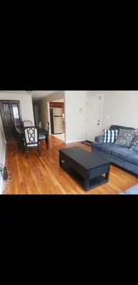 a living room with a couch and a coffee table at Beautiful 3 Bed Vacation home in Newark