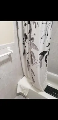 a black and white shower curtain in a bathroom at Beautiful 3 Bed Vacation home in Newark