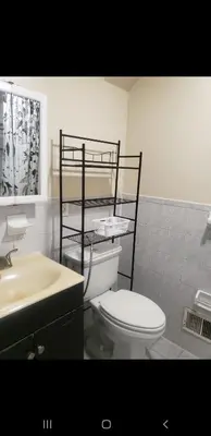 a bathroom with a toilet and a sink at Beautiful 3 Bed Vacation home in Newark