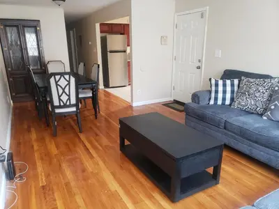 a living room with a couch and a table at Beautiful 3 Bed Vacation home in Newark