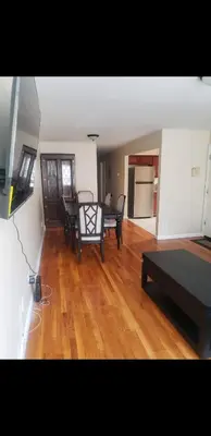 a living room with a table and chairs in it at Beautiful 3 Bed Vacation home in Newark