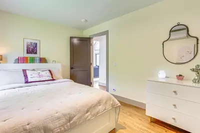 a bedroom with a white bed and a dresser at Walk to Bethel Woods Family Home with Deck and Views! in Swan Lake