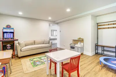 a living room with a table and a couch at Walk to Bethel Woods Family Home with Deck and Views! in Swan Lake