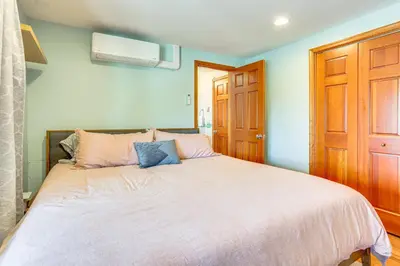 a bedroom with a large bed with blue walls at Walk to Bethel Woods Family Home with Deck and Views! in Swan Lake