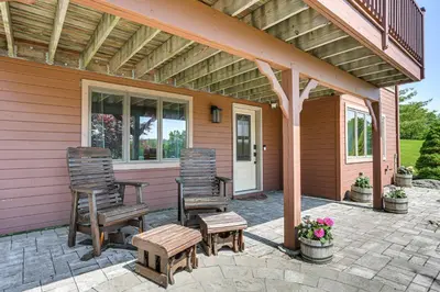 two chairs and a table on a patio at Walk to Bethel Woods Family Home with Deck and Views! in Swan Lake