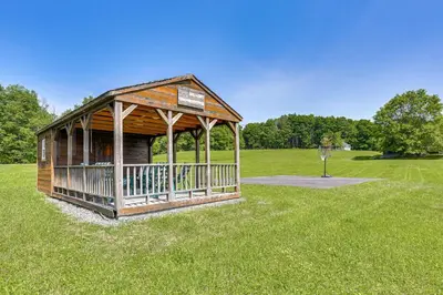 a wooden gazebo in the middle of a field at Walk to Bethel Woods Family Home with Deck and Views! in Swan Lake