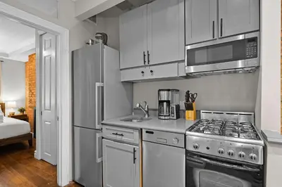 a kitchen with a stove and a refrigerator at Stylish Escape in the East Village in New York