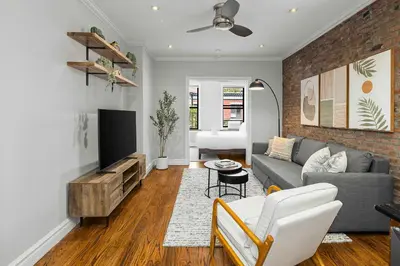 a living room with a couch and a tv at Chic NYC Escape in Vibrant Downtown in New York