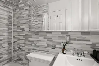 a white bathroom with a sink and a toilet at Chic NYC Escape in Vibrant Downtown in New York