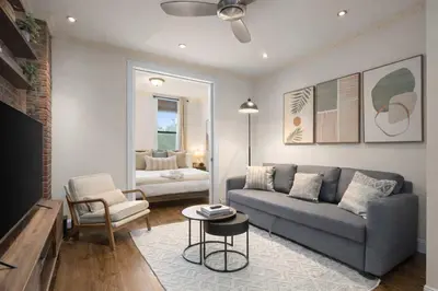 a living room with a couch and a chair at Stylish East Side Escape Steps from Fun in New York