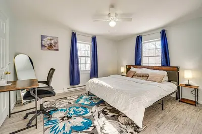 a bedroom with a bed and a desk and a chair at Explore Poconos with Fire pit, Games, Grill in Tobyhanna