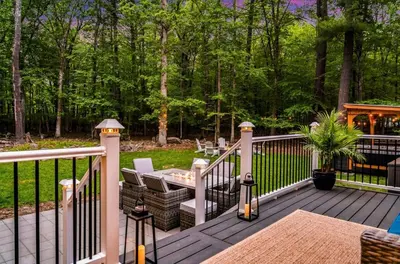 a wooden deck with a table and chairs on it at Dine Outdoors, Dream Indoors 5BR in East Stroudsburg