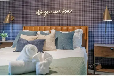 a bed with pillows and a sign that says adjust you more here at Dine Outdoors, Dream Indoors 5BR in East Stroudsburg