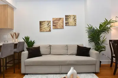 a living room with a couch and a table at Boho Rustic Escape with Masssive Terrace in Midtown in New York